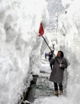 Woman shoveling snow